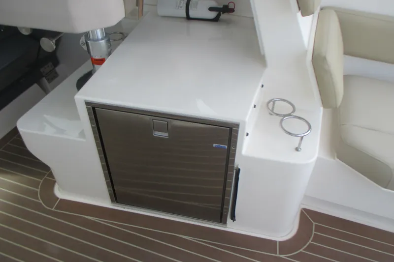 Worth Pursuit Yacht Photos Pics 2013 Pursuit SC 365i Sport Coupe interior with stainless steel fridge and cup holders.