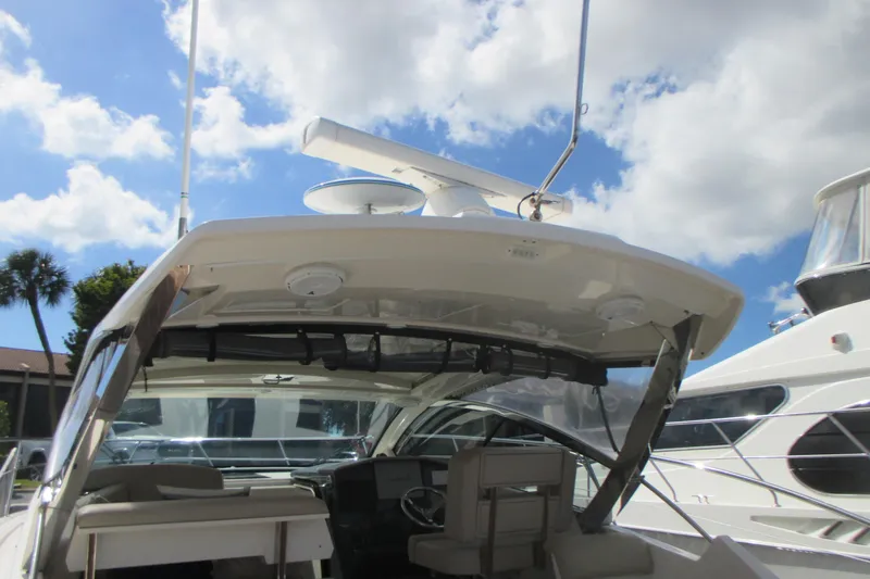 Worth Pursuit Yacht Photos Pics 2013 Pursuit SC 365i Sport Coupe boat with open cockpit under a sunny sky.