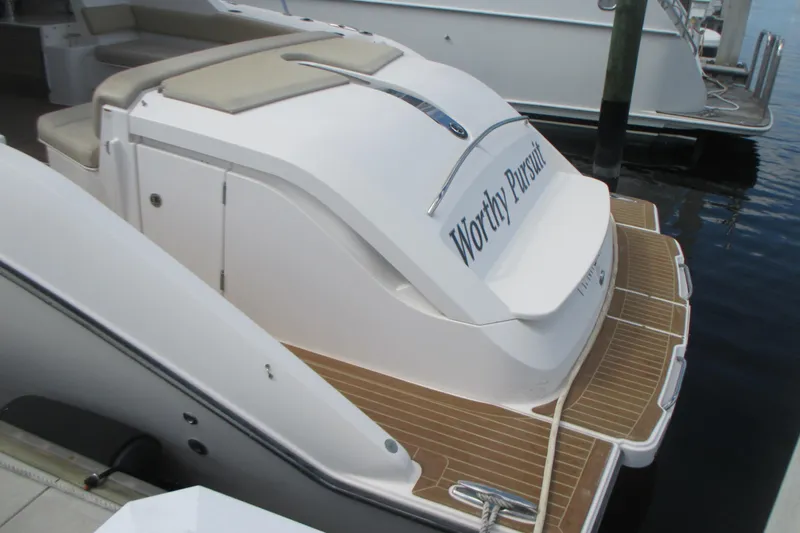 Worth Pursuit Yacht Photos Pics 2013 Pursuit SC 365i Sport Coupe docked, featuring teak swim platform and "Worthy Pursuit" name.