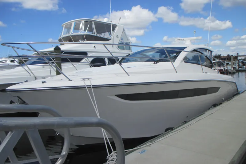 Worth Pursuit Yacht Photos Pics 2013 Pursuit SC 365i Sport Coupe docked at marina under blue sky.