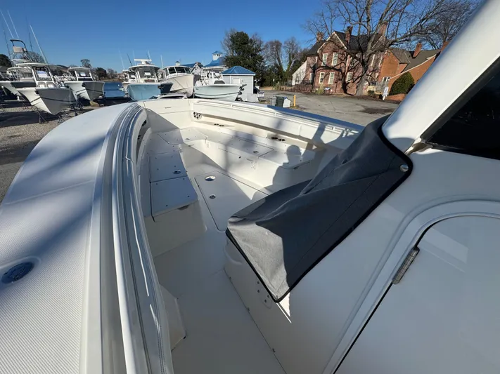 Temp Tag Yacht Photos Pics Regulator 31 boat 2022, spacious deck, sunny day, marina setting.