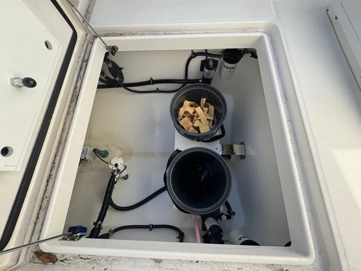 Temp Tag Yacht Photos Pics 2022 Regulator 31 boat with open storage compartment and buckets.