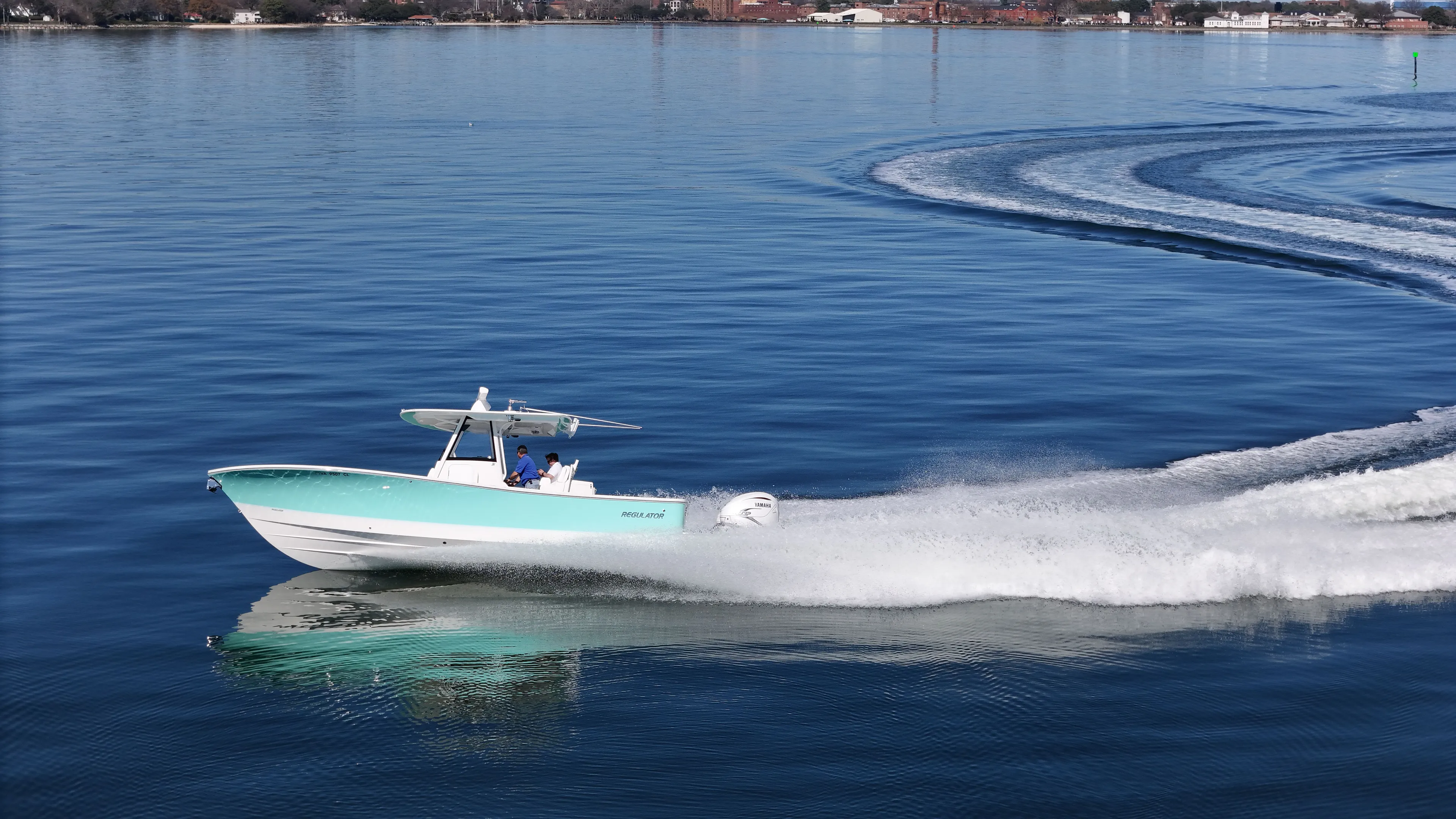 Temp Tag Yacht Photos Pics 2022 Regulator 31 boat speeding on calm water.