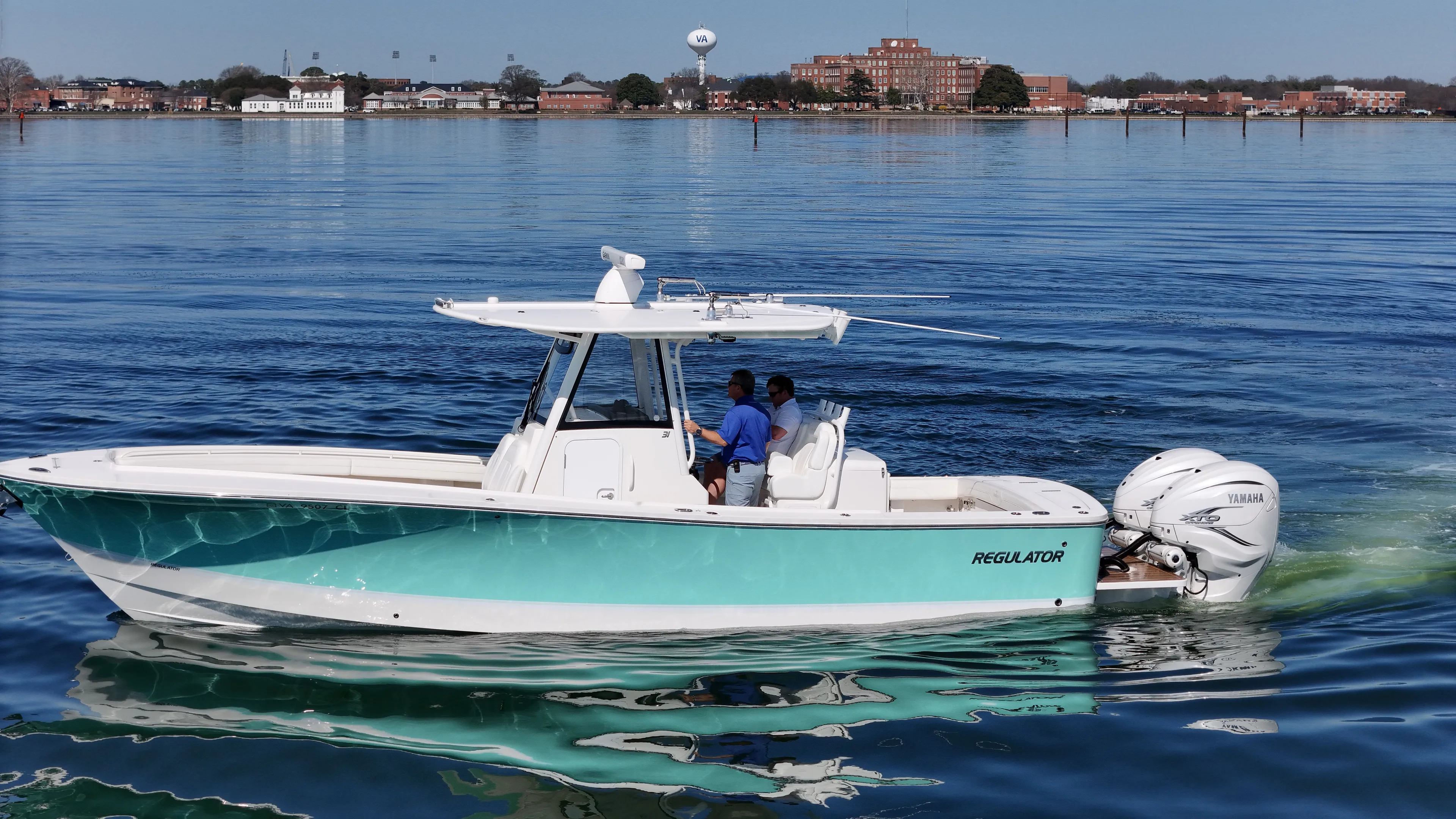 Temp Tag Yacht Photos Pics 2022 Regulator 31 boat on calm water with two people onboard.