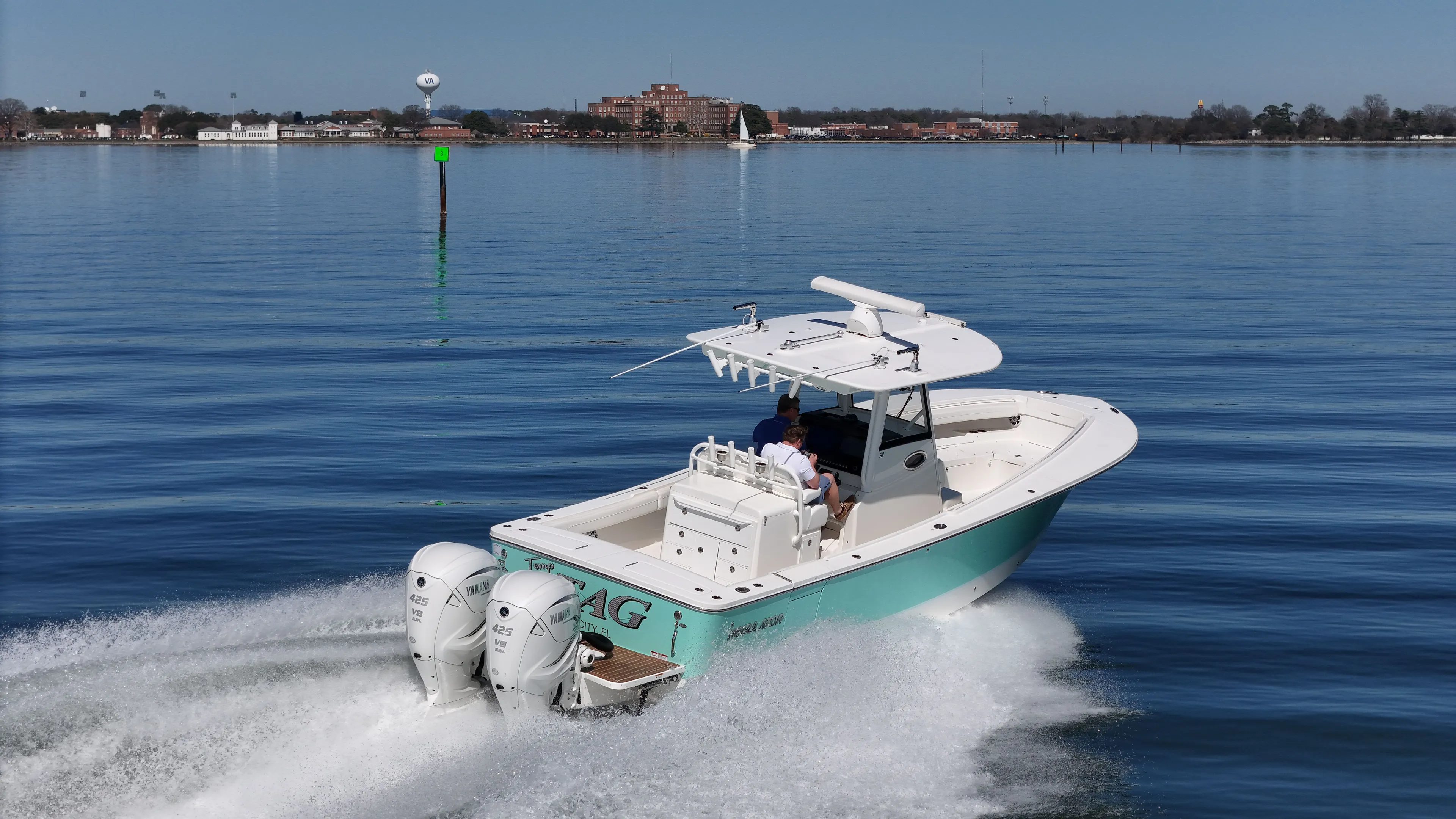 Temp Tag Yacht Photos Pics 2022 Regulator 31 boat on calm water, dual engines, coastal scenery.