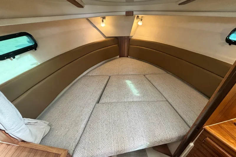  Yacht Photos Pics 2026 Ranger Tugs R-27 cabin interior with cozy seating and ambient lighting.