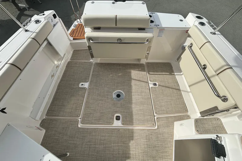  Yacht Photos Pics 2026 Ranger Tugs R-27 boat interior with beige seating and non-slip flooring.