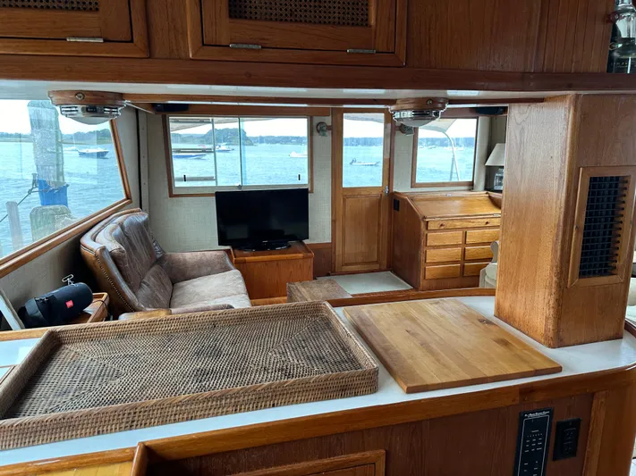 Gitana Yacht Photos Pics Interior of 1986 Wilbur Hunt Yachts with wood finish, seating, and waterfront view.