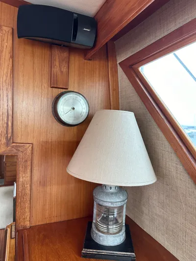 Gitana Yacht Photos Pics 1986 Wilbur Hunt Yachts interior with lamp, clock, and speaker on wooden paneling.