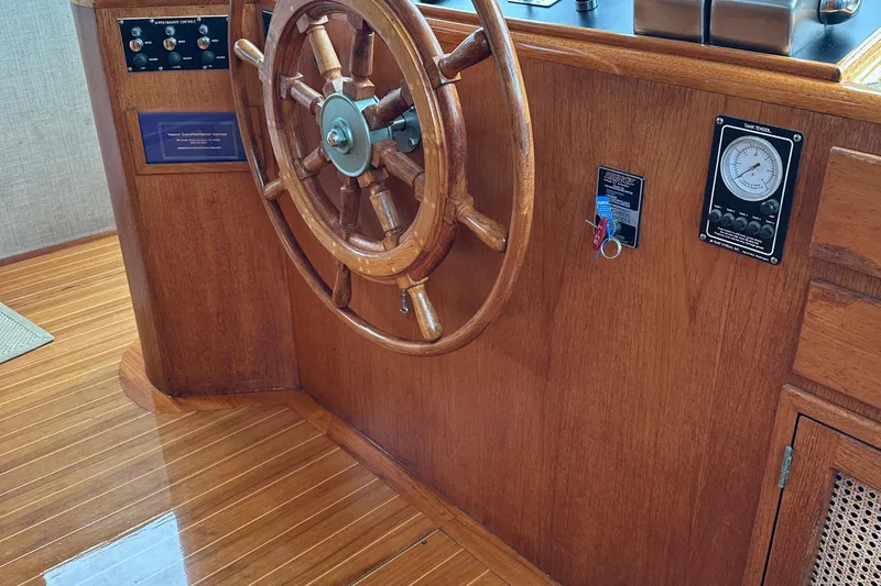 Gitana Yacht Photos Pics Wooden helm of 1986 Wilbur Hunt Yachts, featuring classic nautical design and polished finish.