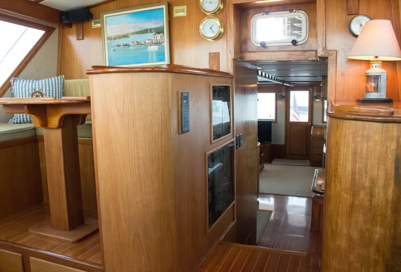 Gitana Yacht Photos Pics 1986 Wilbur Hunt Yachts interior with wood paneling, nautical decor, and cozy seating area.