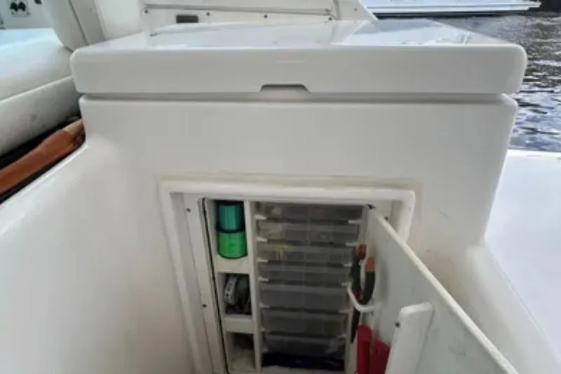  Yacht Photos Pics Storage compartment on a 2000 Tiara 37 Open boat, featuring organized fishing gear.