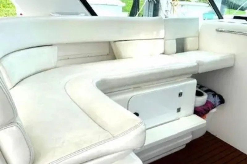  Yacht Photos Pics Interior seating of 2000 Tiara 37 Open yacht, featuring white cushioned benches.