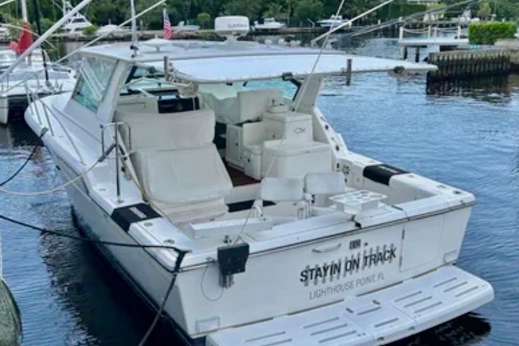 2000 Tiara 37 Open yacht docked at marina, rear view, named "Stayin' On Track".