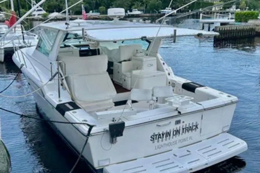 2000 Tiara 37 Open yacht docked at marina, rear view, named "Stayin' On Track".