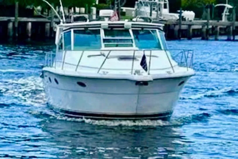 2000 Tiara 37 Open yacht cruising on a calm waterway.