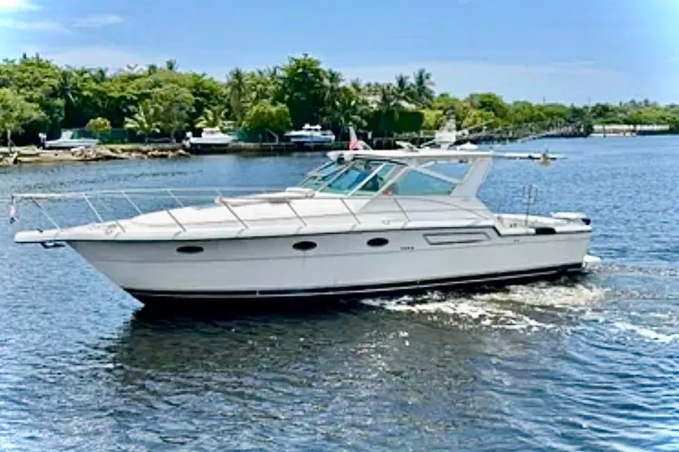 2000 Tiara 37 Open yacht cruising on a sunny day in a scenic waterway.