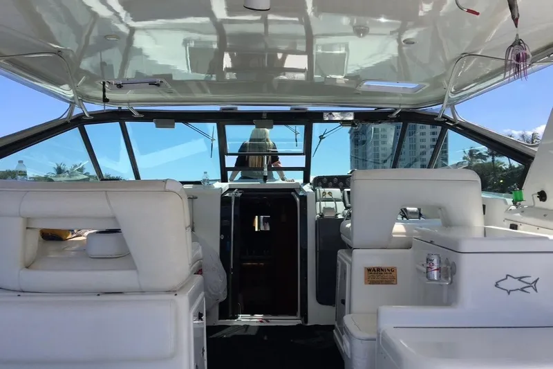  Yacht Photos Pics Interior view of a 2000 Tiara 37 Open yacht with white seating and helm.