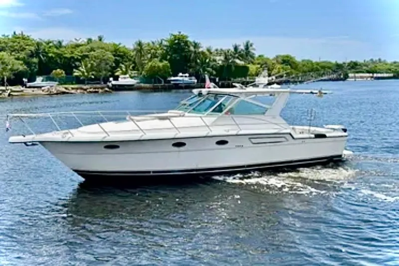  Yacht Photos Pics 2000 Tiara 37 Open yacht cruising on a sunny day in a scenic waterway.