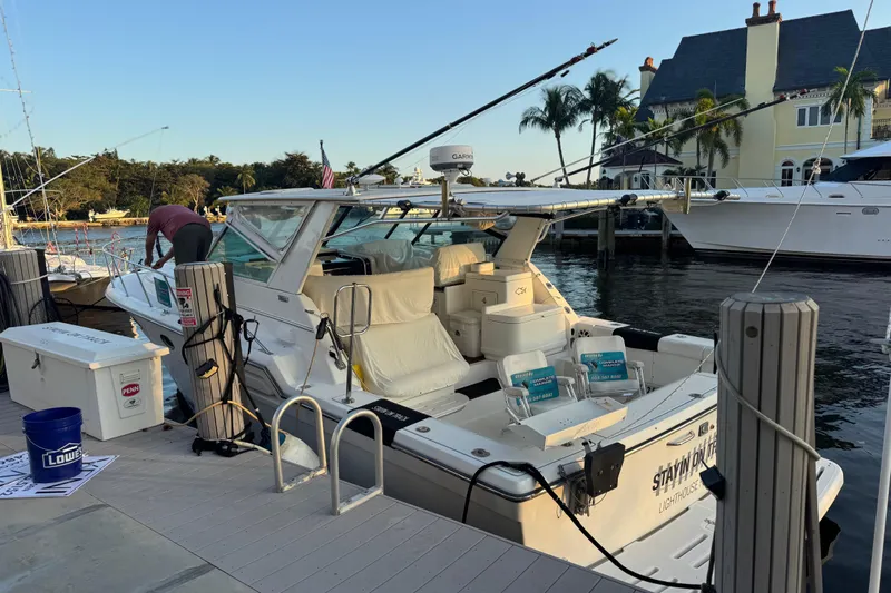  Yacht Photos Pics 2000 Tiara 37 Open yacht docked at marina with fishing gear and scenic waterfront view.