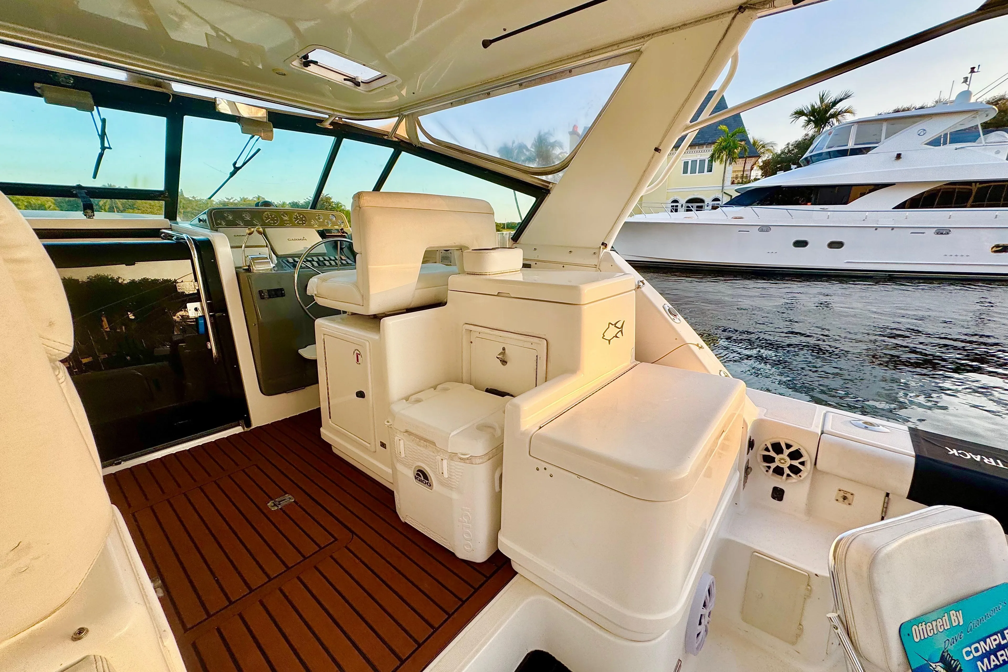 Interior of 2000 Tiara 37 Open yacht with seating and helm, docked by water.