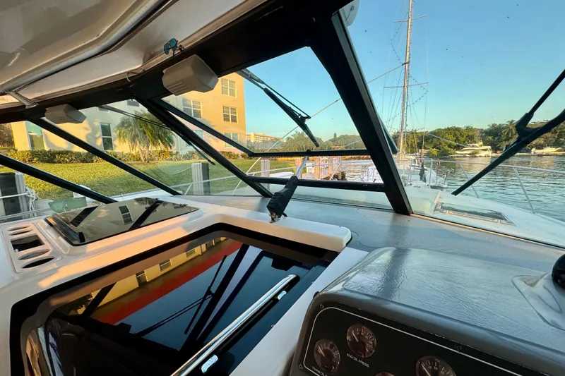  Yacht Photos Pics Interior view of 2000 Tiara 37 Open yacht cockpit with marina backdrop.