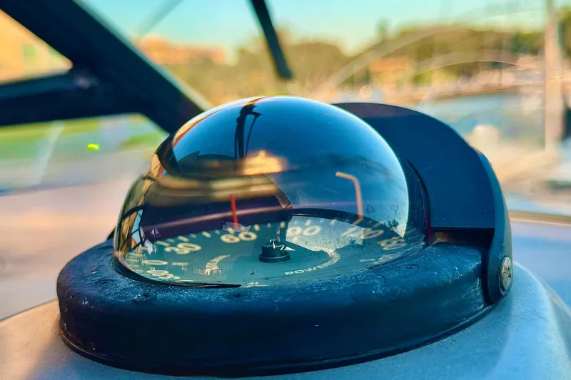  Yacht Photos Pics Close-up of a compass on a 2000 Tiara 37 Open boat, with blurred background.