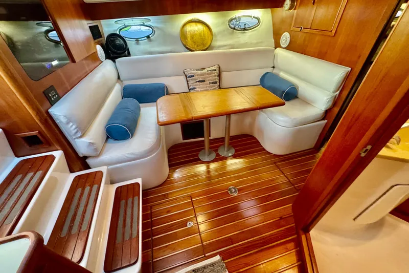  Yacht Photos Pics Luxurious interior of 2000 Tiara 37 Open yacht with wooden flooring and cozy seating.