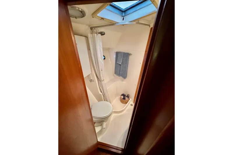  Yacht Photos Pics Compact bathroom in 2000 Tiara 37 Open yacht with skylight and shower.
