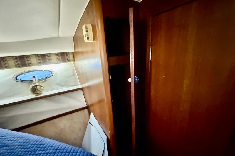  Yacht Photos Pics Interior of 2000 Tiara 37 Open yacht with wooden cabinetry and porthole.