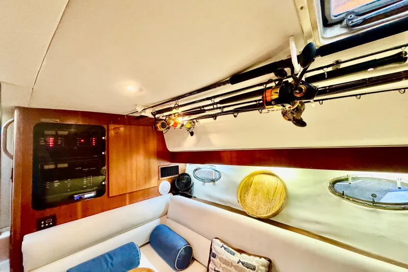  Yacht Photos Pics Interior of 2000 Tiara 37 Open yacht with fishing rods and cozy seating area.