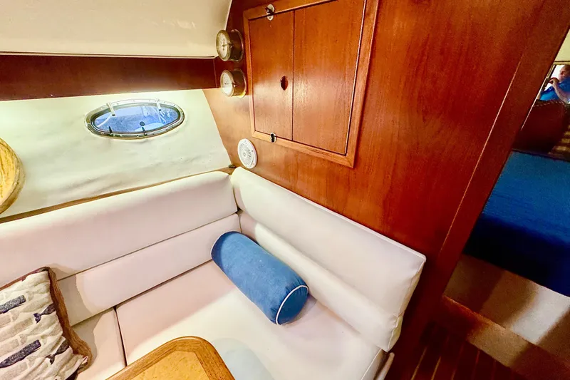  Yacht Photos Pics Interior of 2000 Tiara 37 Open yacht with white seating and wooden accents.