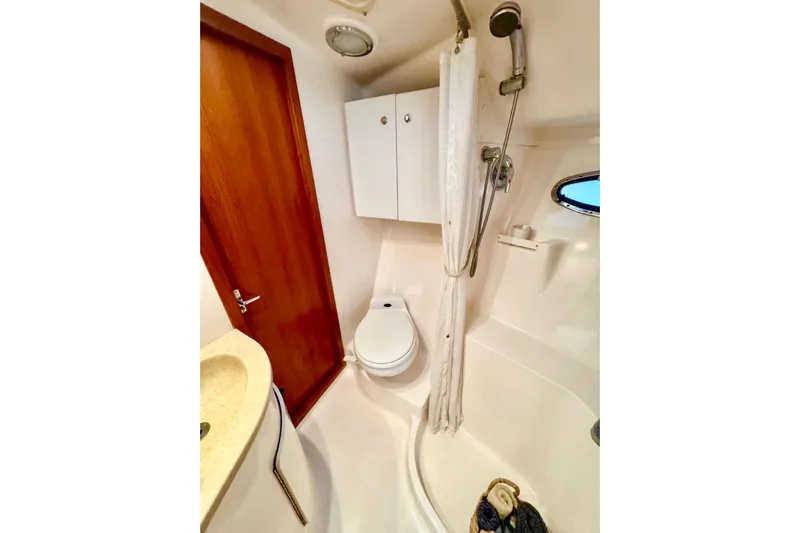  Yacht Photos Pics Bathroom in 2000 Tiara 37 Open yacht with shower, toilet, and sink.