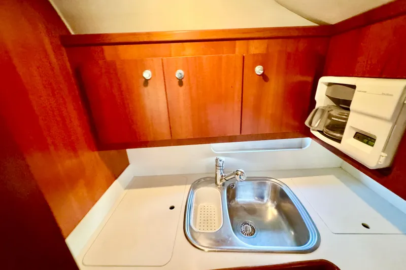  Yacht Photos Pics Compact kitchen area in a 2000 Tiara 37 Open boat with sink and coffee maker.