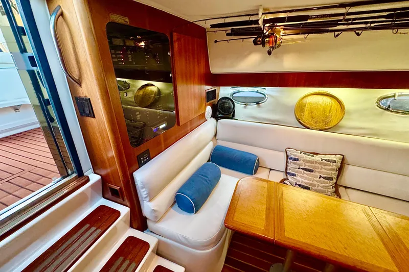  Yacht Photos Pics Interior of 2000 Tiara 37 Open yacht with cozy seating and wooden accents.