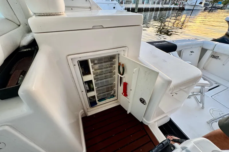  Yacht Photos Pics 2000 Tiara 37 Open boat with open storage compartment and fishing gear.