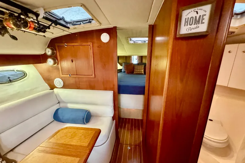  Yacht Photos Pics Interior of 2000 Tiara 37 Open yacht with cozy seating and wooden finishes.
