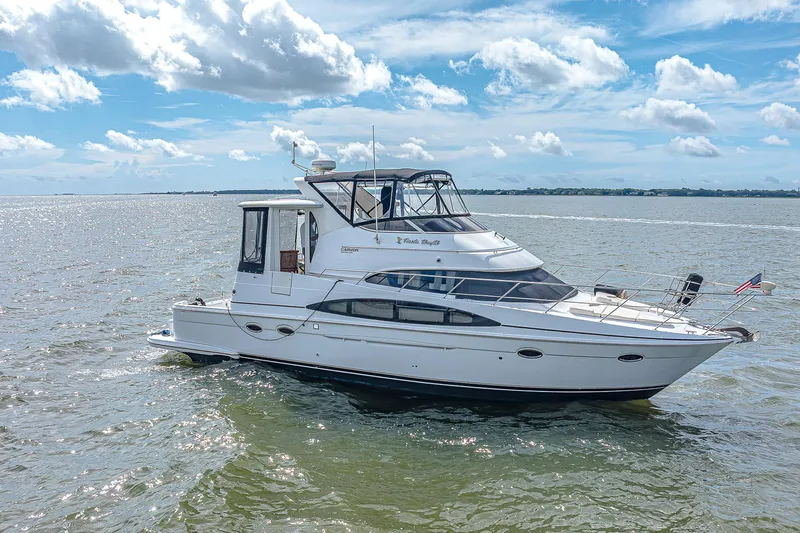 Fiesta Bayb Yacht Photos Pics 2003 Carver 444 Cockpit Motor Yacht cruising on open water under a bright blue sky.