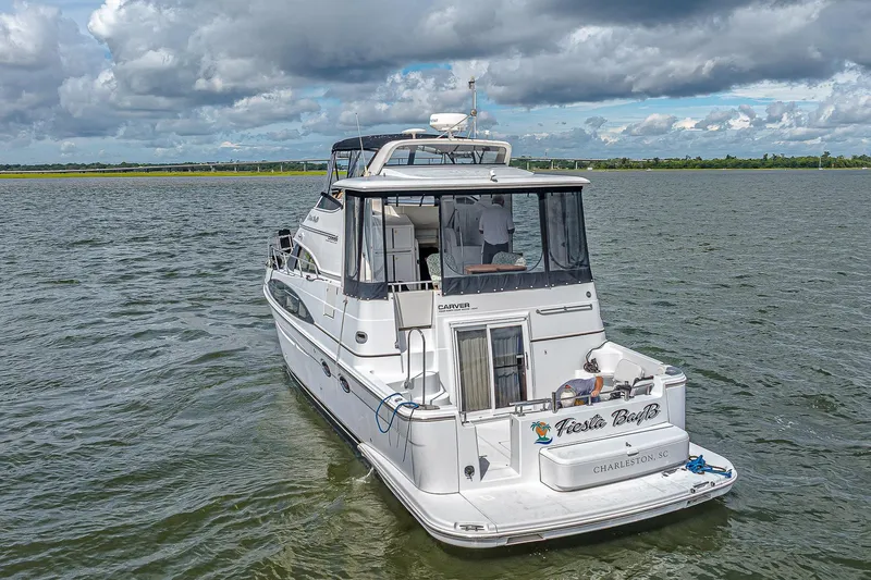 Fiesta Bayb Yacht Photos Pics 2003 Carver 444 Cockpit Motor Yacht on open water under cloudy skies.