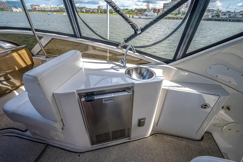 Fiesta Bayb Yacht Photos Pics 2003 Carver 444 Cockpit Motor Yacht interior with sink and mini fridge, overlooking water.