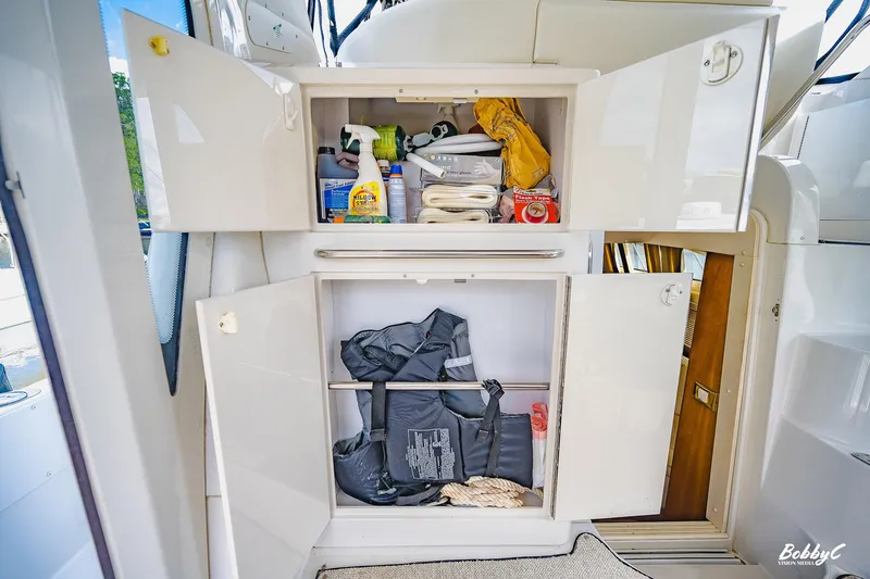 Fiesta Bayb Yacht Photos Pics Storage cabinet on 2003 Carver 444 Cockpit Motor Yacht with cleaning supplies and life jackets.