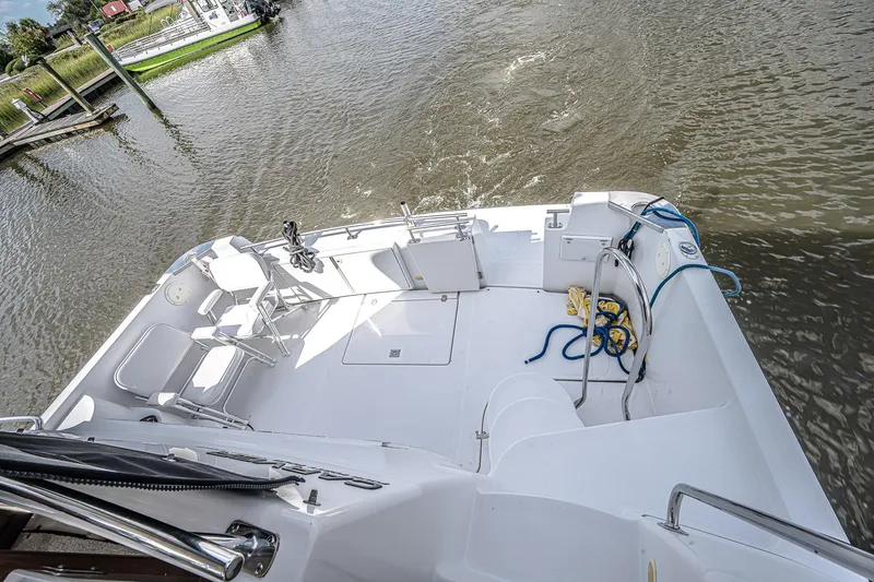 Fiesta Bayb Yacht Photos Pics 2003 Carver 444 Cockpit Motor Yacht on calm water, featuring spacious deck and seating area.