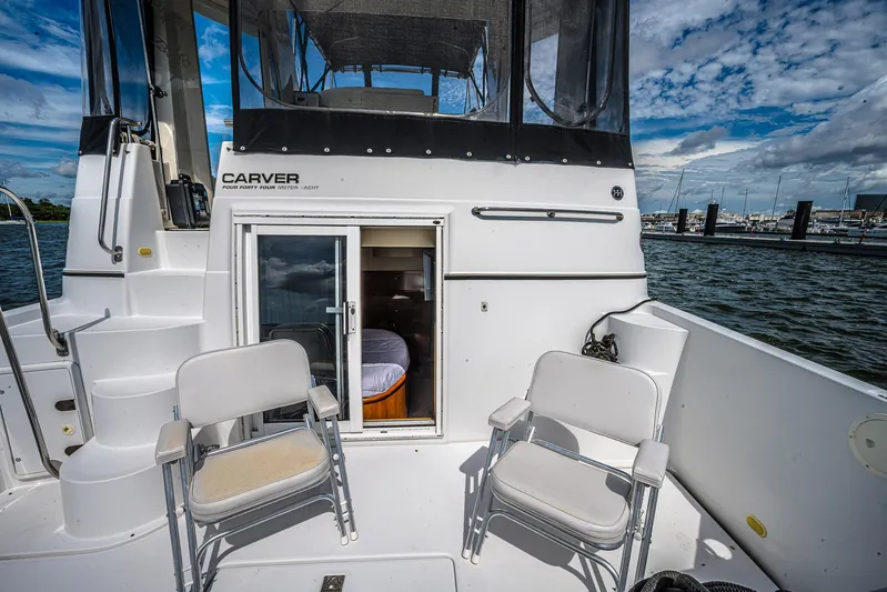 Fiesta Bayb Yacht Photos Pics 2003 Carver 444 Cockpit Motor Yacht with chairs on deck, marina view.