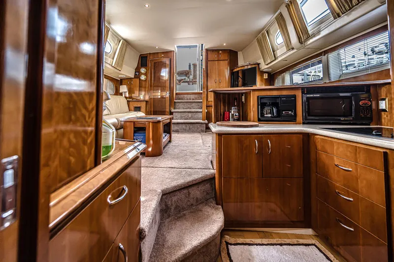 Fiesta Bayb Yacht Photos Pics Luxurious interior of 2003 Carver 444 Cockpit Motor Yacht with wood cabinetry and modern appliances.