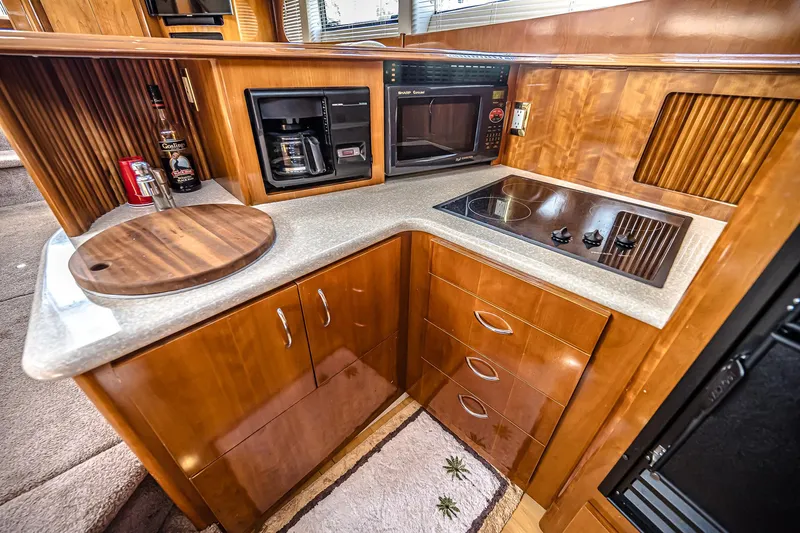 Fiesta Bayb Yacht Photos Pics Luxurious 2003 Carver 444 Cockpit Motor Yacht kitchen with modern appliances and wooden cabinetry.