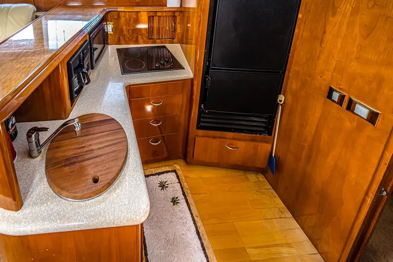 Fiesta Bayb Yacht Photos Pics 2003 Carver 444 Cockpit Motor Yacht kitchen with wood cabinetry and modern appliances.