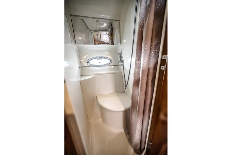 Fiesta Bayb Yacht Photos Pics Bathroom interior of 2003 Carver 444 Cockpit Motor Yacht with shower and porthole window.