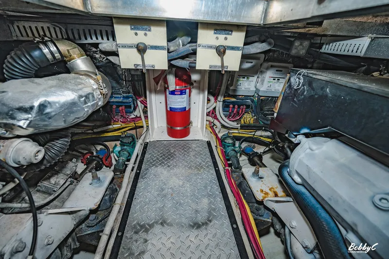 Fiesta Bayb Yacht Photos Pics Engine room of 2003 Carver 444 Cockpit Motor Yacht with visible machinery and fire extinguisher.