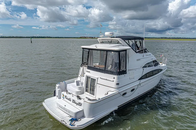 Fiesta Bayb Yacht Photos Pics 2003 Carver 444 Cockpit Motor Yacht cruising on open water under cloudy skies.