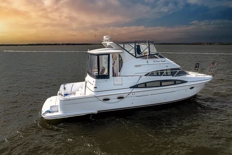 Fiesta Bayb Yacht Photos Pics 2003 Carver 444 Cockpit Motor Yacht cruising on open water at sunset.